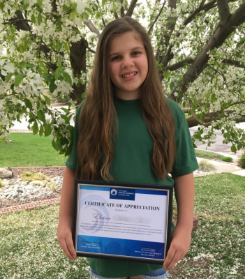 Elaina proudly displays her certificate of appreciation from the NMMF, a testament to her dedication and contributions to vaquita conservation.